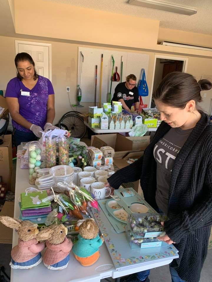 Parents as Teachers AmeriCorps members from United Way of El Paso County pack spring-themed care packages for local families using donations of Easter inventory from local retailer World Market.