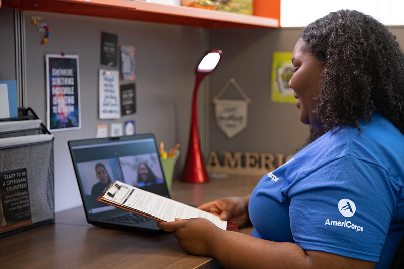 AmeriCorps member in blue shirt on a video conference call
